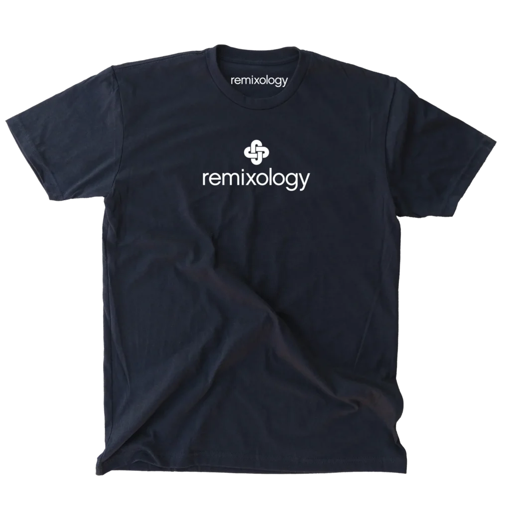 A white background with a single black T-shirt. The T-shirt has the white Remixology logo on the front and the logo on the neck label.